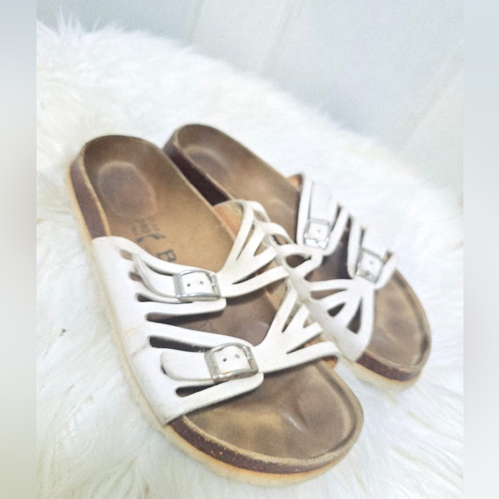 White Birkenstock Granada soft footbed sandals with adjustable buckle straps.